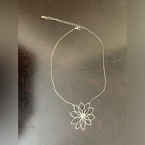 Silver tone snowflake flower sparkling necklace with center zirconia.